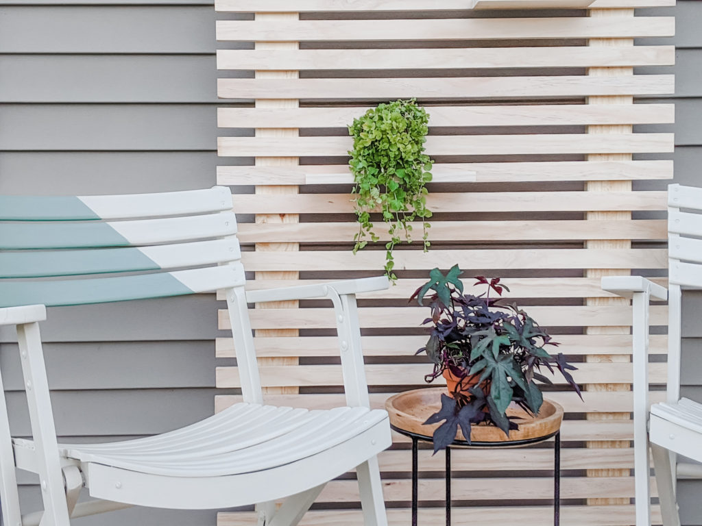 Close up of Painted Chairs and Wood Slat Plant Wall