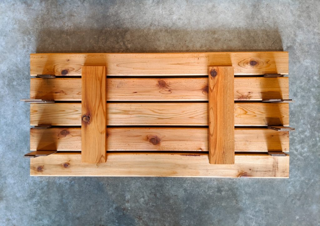 Putting together the lid for the storage container part of the bench