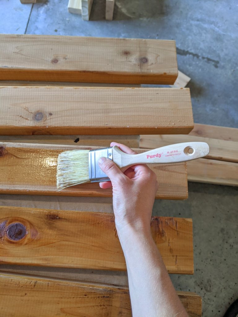 Adding a protective oil to cedar wood using a Purdy White Bristle brush