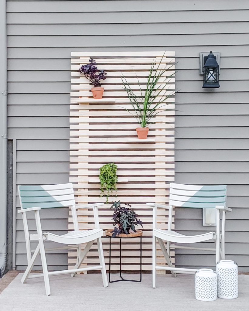 After Picture of Patio Makeover Including Painted Chairs and Plant Wall