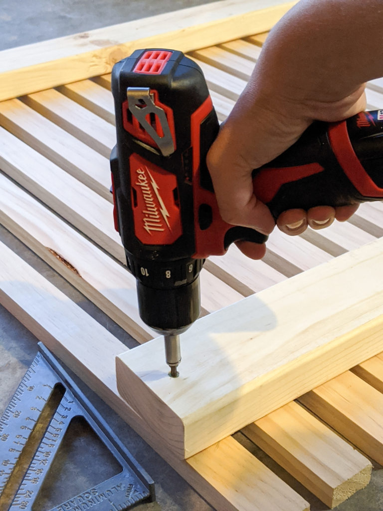 Attaching the slats to the 2x4s with a drill