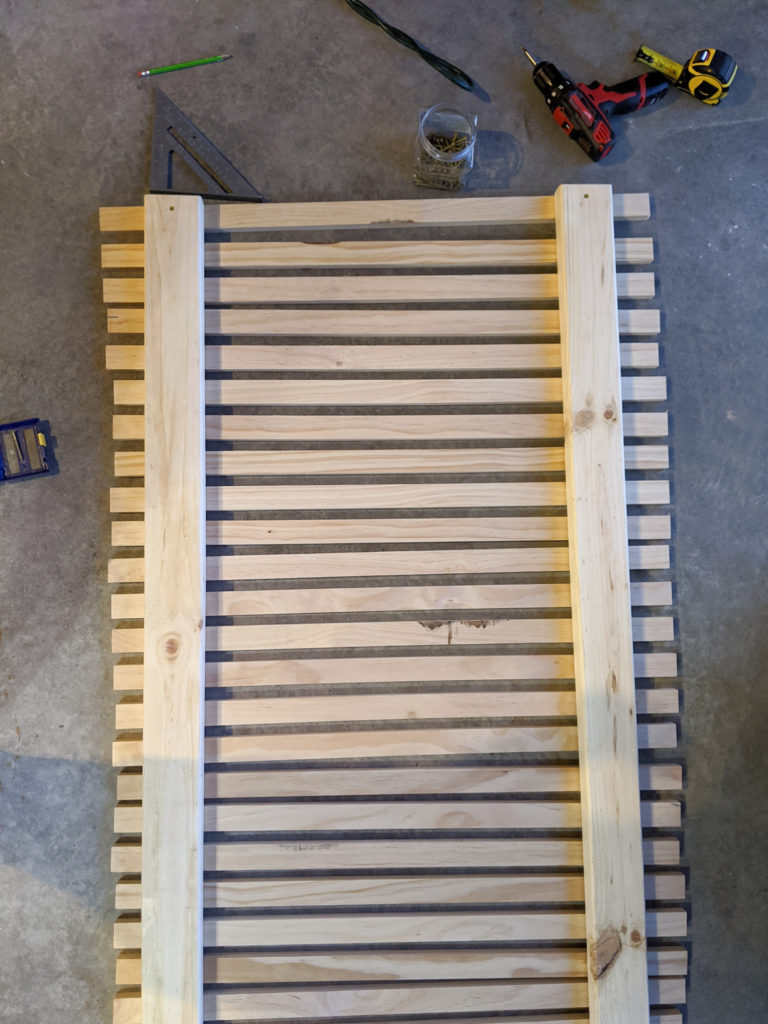 Laying out the boards for the wood slat planter wall