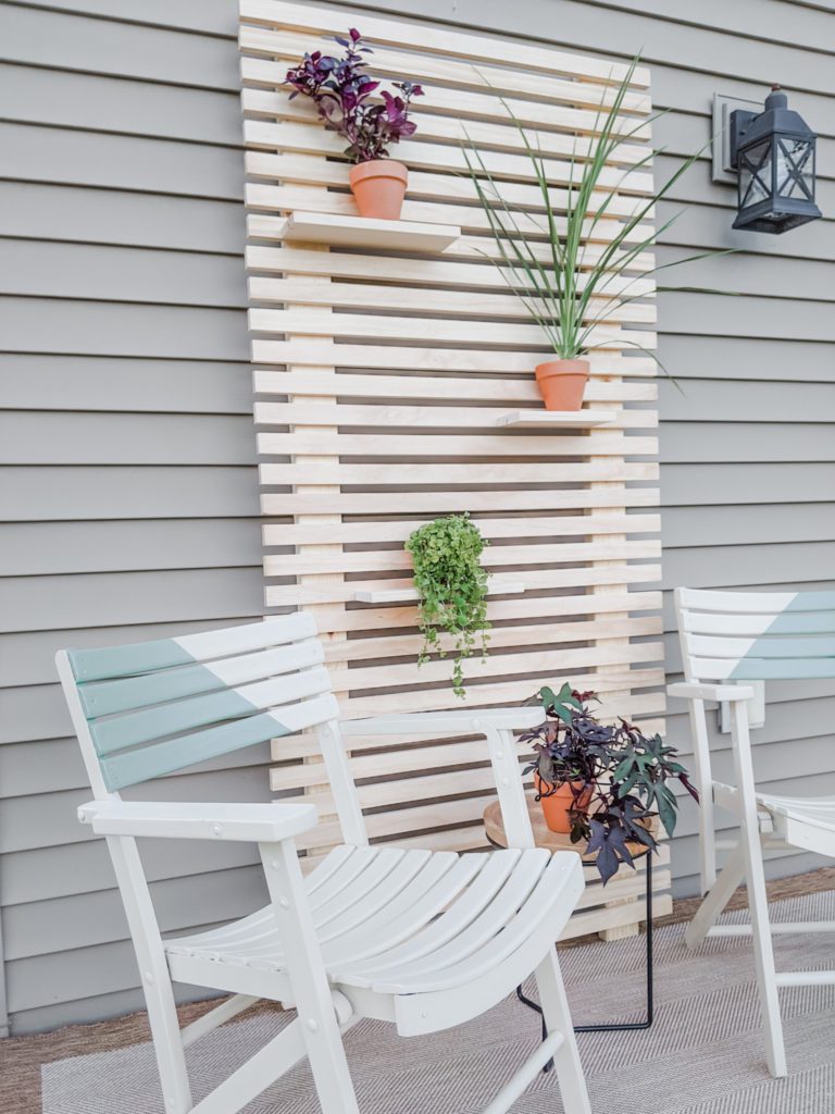 Side View of Finished Patio Makeover with Painted Chairs and Wood Slat Plant Wall