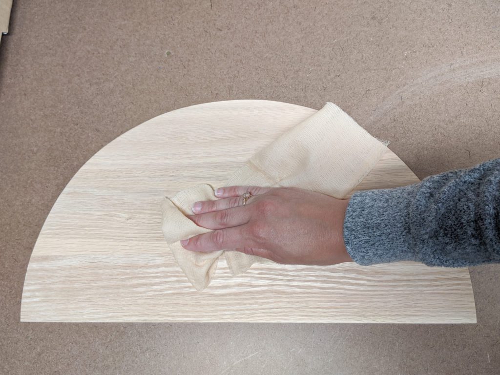 Wiping off wood with tack cloth