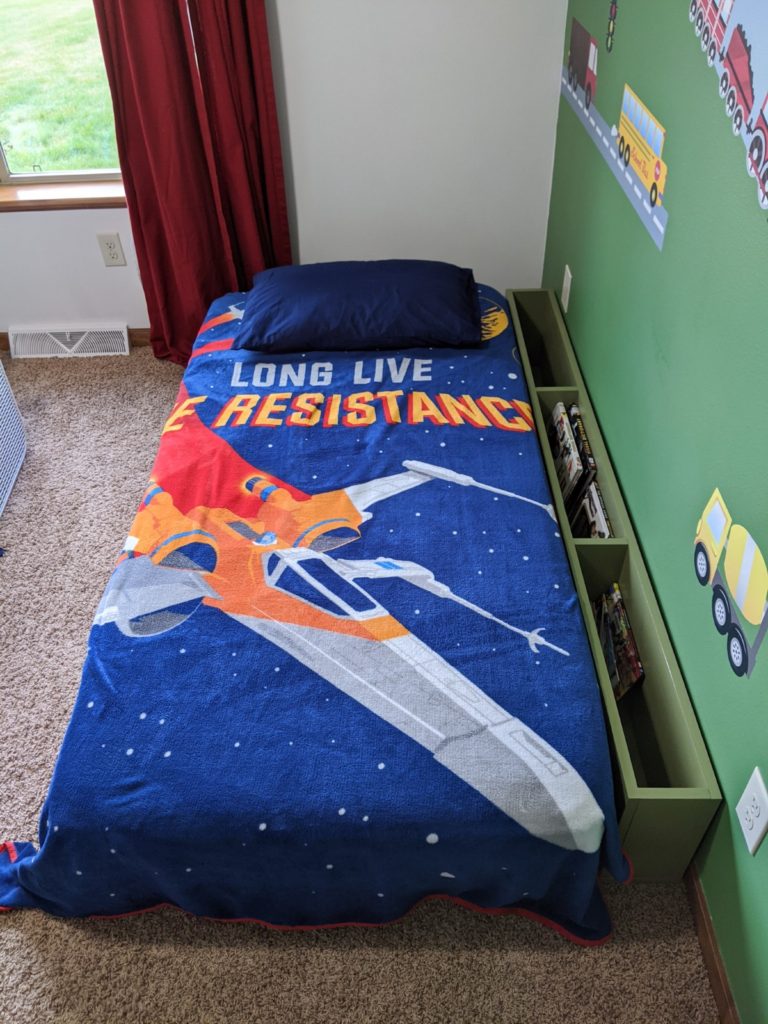 Bedside Storage Cubby Next to Child's Star Wars themed bed