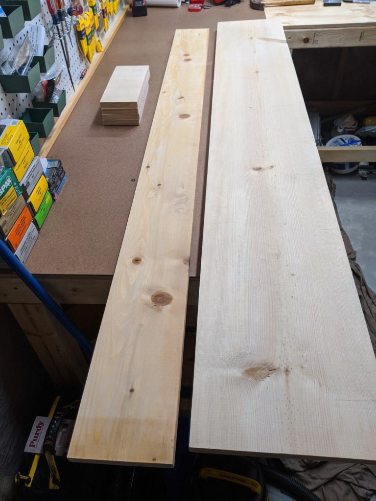 Pine boards cut into sections for bedside cubby