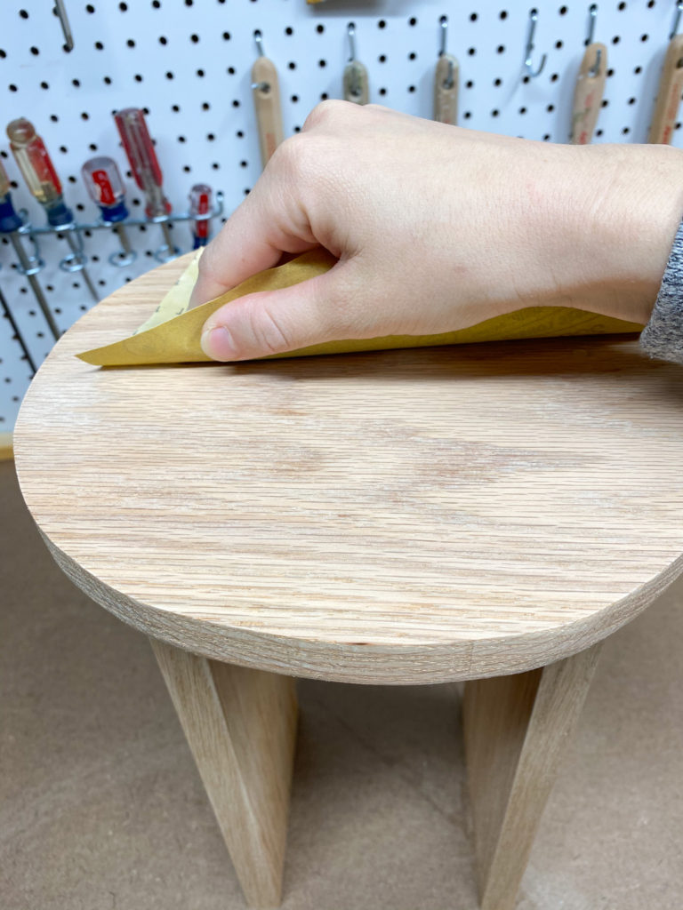 Sanding the stool with 220 grit sandpaper