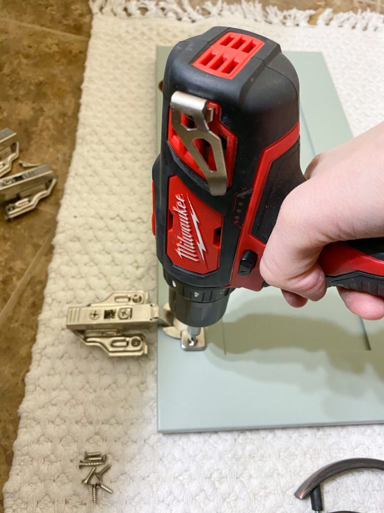 Putting doors back on vanity after painting bathroom cabinets