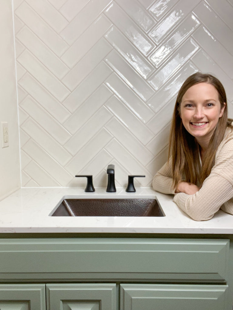 Me with installed bathroom sink, countertop, faucet and tile