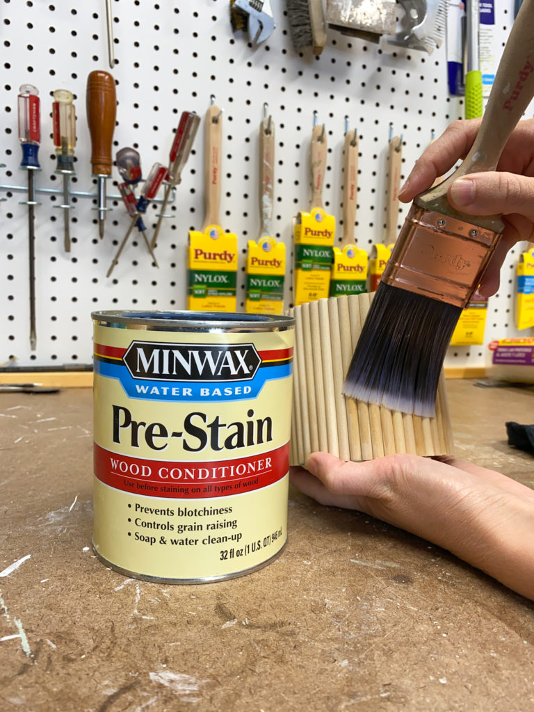 Applying prestain wood conditioner to dowel planters