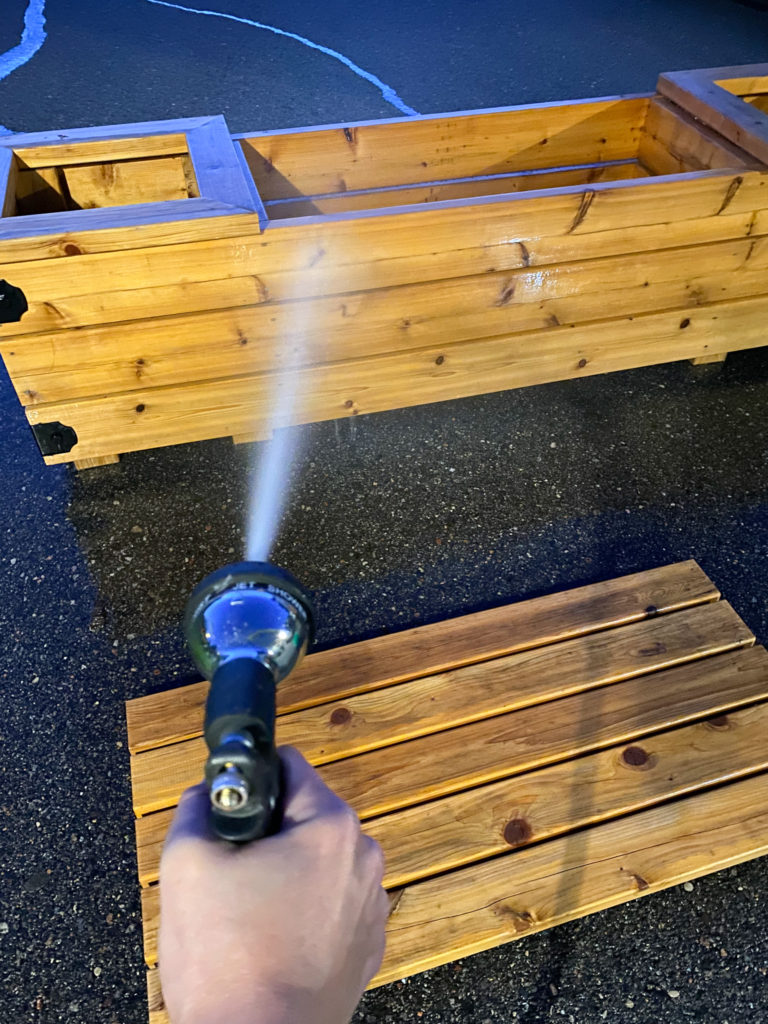 Spraying off Cabot Wood Cleaner before applying oil