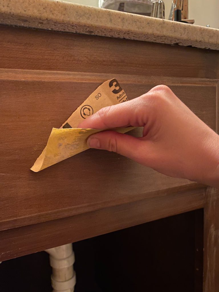 Sanding Cabinets with 220 grit sandpaper before painting