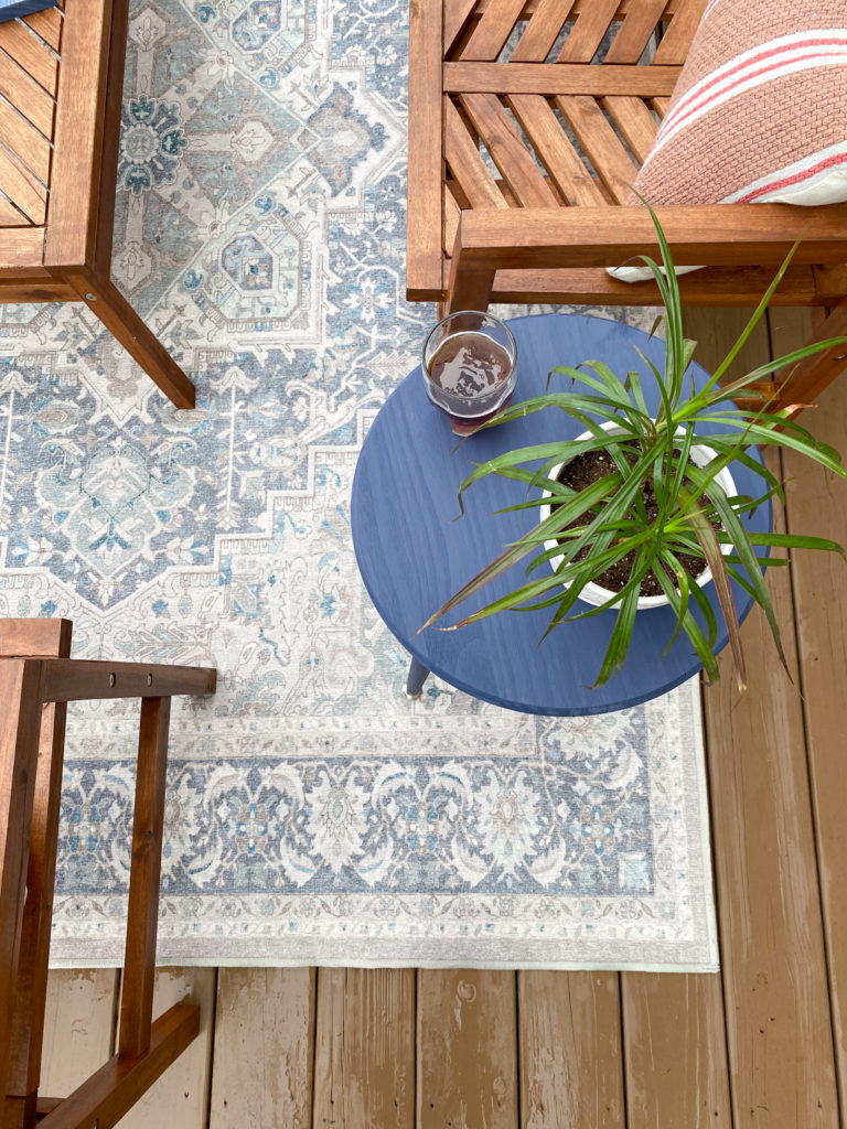 Closeup view of Cabot-stained end tables on patio with plant