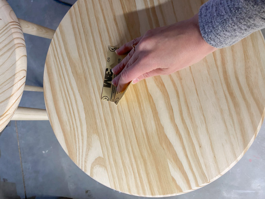 Sanding down wood tables to prepare for stain